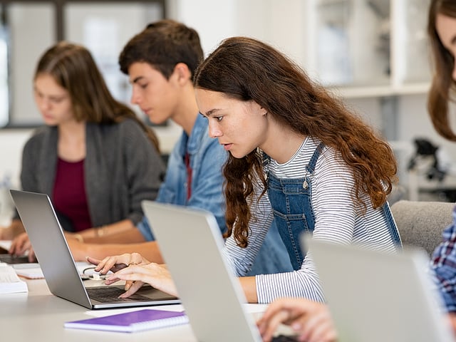 students taking test laptop.jpg