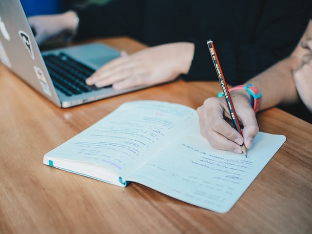 jotting notes in notebook.jpg