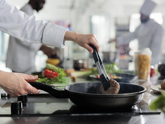 chef picking up meat.jpg