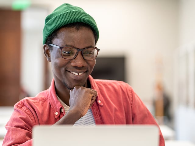 man smiling at computer.jpg