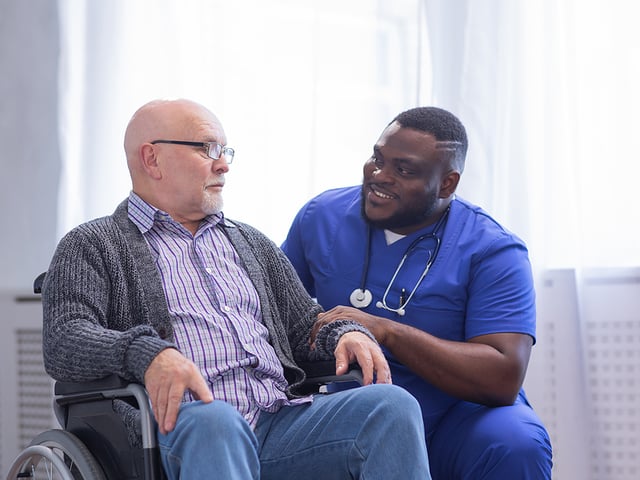 african american caregiver and man wheelchair.jpg