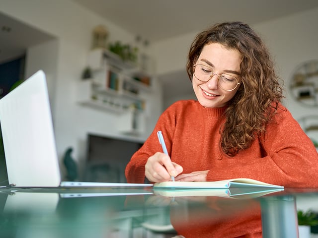 young woman smiling studying.jpg