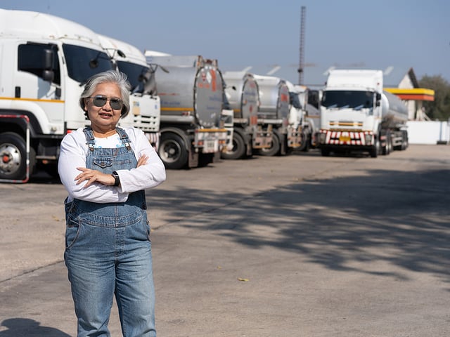 female truck driver with trucks.jpg
