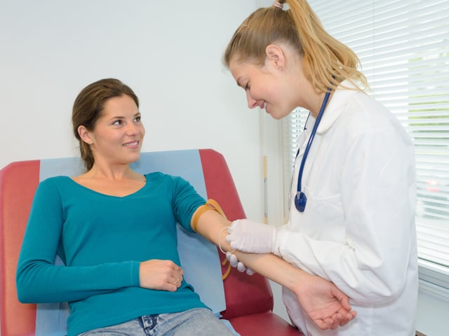 medical assistant helping female patient.jpg