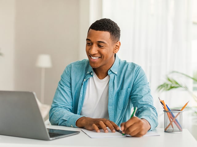 African American Man Smiling Computer.jpg