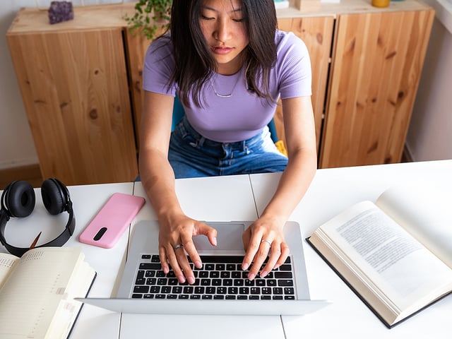 young asian woman studying with laptop.jpg
