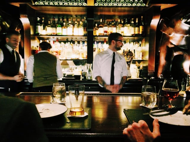man in tie behind bar.jpg
