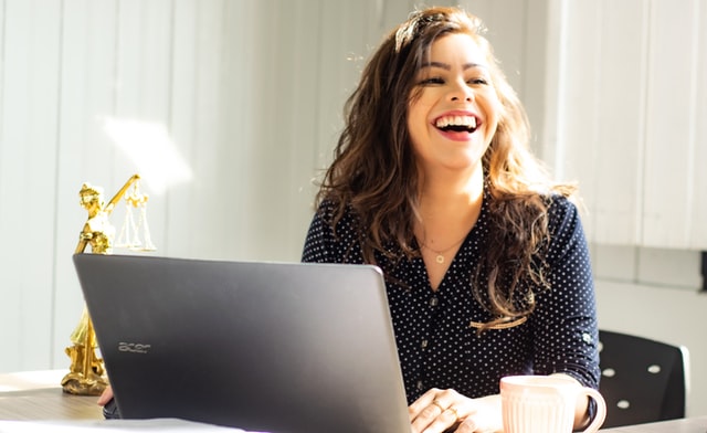 woman smiling in front of computer.jpg